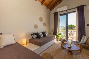 a living room with a couch and a table at Poesia Suites in Lakithra