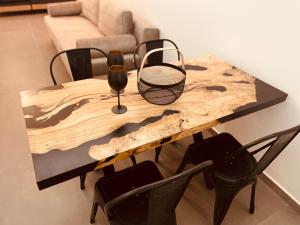 a wooden table with two wine glasses and chairs at Loft Athens -Nomad Friendly # SuperHost hub# in Athens