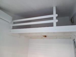 a white bunk bed in a white room at bleu intense in La Trinité