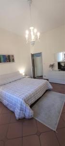 a bedroom with a large bed with a blue blanket at B&B Via della Grotta in Monsummano