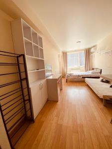 a large room with two beds and a large window at Let flat today in Kyiv