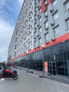 a red motorcycle parked in front of a building at Let flat today in Kyiv