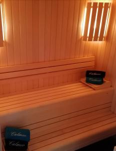 a sauna with two books sitting on a bench at Chambre avec Spa et Sauna privatisés in Bourg-en-Bresse