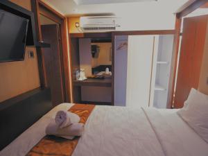 a woman laying on a bed in a hotel room at Sari Gili Bungalow in Gili Islands