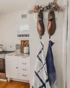 a kitchen with two wooden utensils hanging on the wall at Rooisee in Yzerfontein