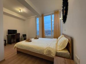 a bedroom with a bed and a large window at NEW Central nr5 Self Checkin OldCity Center Paid Parking with Lift in Timişoara