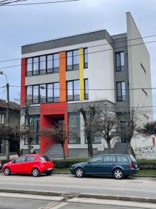 two cars parked in front of a building at NEW Central nr5 Self Checkin OldCity Center Paid Parking with Lift in Timişoara