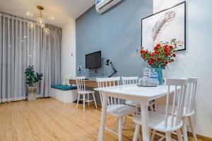 jadalnia z białym stołem i krzesłami w obiekcie The Peony Apartment w Ho Chi Minh