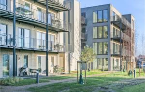 an apartment building with a fire hydrant in front of it at Cozy Apartment In Lembruchdümmer See in Lembruch