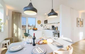 a kitchen and living room with a table and chairs at Cozy Apartment In Lembruchdümmer See in Lembruch