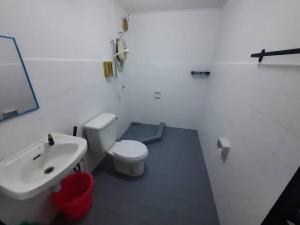 a bathroom with a white toilet and a sink at XHQ Home Stay - BayView B-9-1 in Kampong Baharu