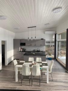 a kitchen and dining room with a table and chairs at Kemping in Föglö
