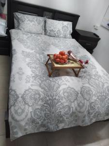 a bed with a tray of fruit on it at Farber Couple house in Nahariyya