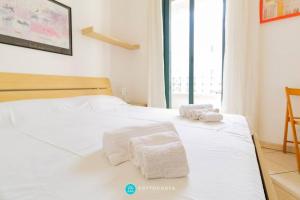 - une chambre avec 2 serviettes blanches sur un lit dans l'établissement CENTRAL SQUARE - San Foca, à San Foca