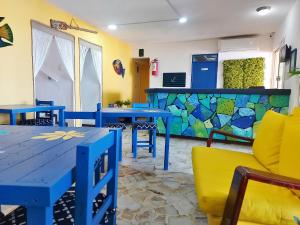 a dining room with blue tables and yellow chairs at HOTEL INTI in Boca del Río