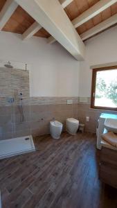 a bathroom with two sinks and two toilets in it at CASA MIA in Solanas