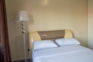 Postel nebo postele na pokoji v ubytování Gracieus Residences