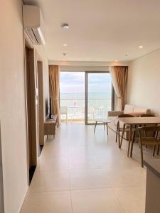 a living room with a view of the ocean at The Sóng Vũng Tàu - Căn hộ 5 sao in Vung Tau