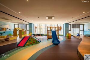 una sala giochi per bambini con scivolo e parco giochi di The Sóng Vũng Tàu - Căn hộ 5 sao a Vung Tau