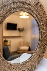 a mirror reflection of a living room with a couch at Le Bussy Studio Disney in Bussy-Saint-Georges