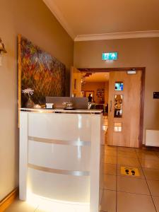 a lobby with a counter with a laptop on it at Moycarn Lodge & Marina in Ballinasloe