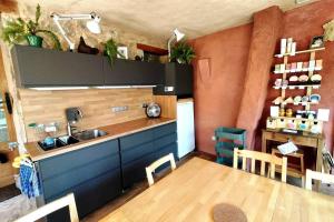 a kitchen with a sink and a table with chairs at Chasteuil Locations Studio in Castellane