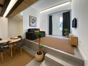 a living room with a couch and a table at Apostolos Loft in Évora