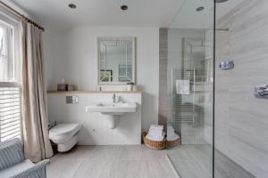 a bathroom with a toilet and a sink and a shower at The Idle Rocks in Saint Mawes