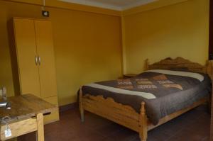 Postel nebo postele na pokoji v ubytování Hostal Coronel Pedro Arraya