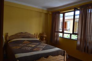Postel nebo postele na pokoji v ubytování Hostal Coronel Pedro Arraya