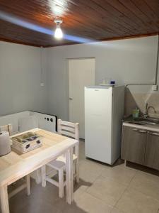 a kitchen with a wooden table and a refrigerator at Departamento amoblado 1 Dtorio in Corrientes