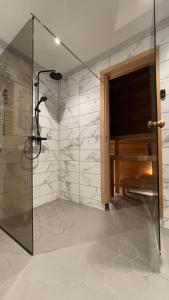 a bathroom with a shower with a glass door at Manni Homestay in Kuressaare