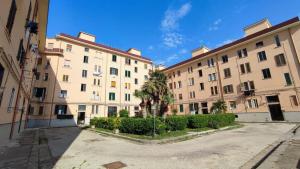 an empty street in front of two large buildings at L'Aurora Guest House in Castellammare di Stabia