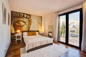 a bedroom with a bed and a large window at Can Agua IBIZA - Fantastic Villa with pool & BBQ in Sant Josep de sa Talaia