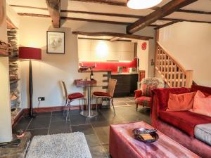 a living room with a red couch and a table at The Curious Orange in Windermere