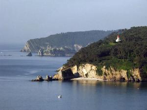 a lighthouse on an island in a body of water at L'Imprenable vue mer in Crozon