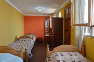Postel nebo postele na pokoji v ubytování Hostal Coronel Pedro Arraya