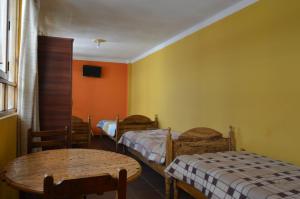 Postel nebo postele na pokoji v ubytování Hostal Coronel Pedro Arraya