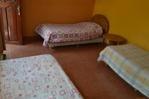 Postel nebo postele na pokoji v ubytování Hostal Coronel Pedro Arraya