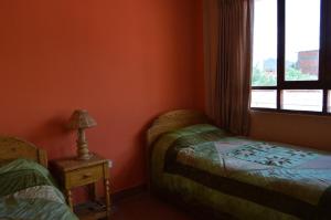 Postel nebo postele na pokoji v ubytování Hostal Coronel Pedro Arraya