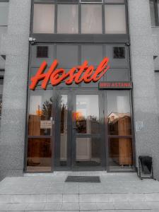 a store front with a red neon sign on it at Hostel Bro Astana in Astana
