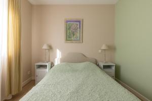 um quarto com uma cama grande e 2 mesas de cabeceira em LaConciergerieJonzac, Maison de ville ALAMBIC em Jonzac