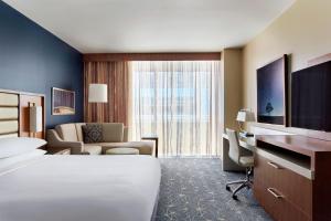 a hotel room with a bed and a desk at Marriott Marquis Houston in Houston