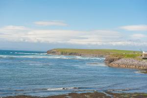 uma vista para o oceano a partir de uma praia em Allingham Arms Hotel em Bundoran