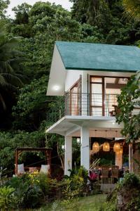 a house with a blue roof at Villa Kulintang in Donsol