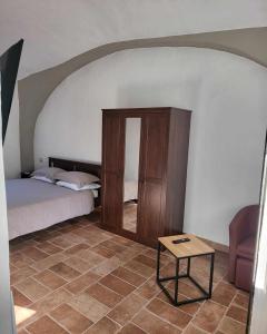 a bedroom with a bed and a table in a room at La Bolgora Guesthouse in Novara