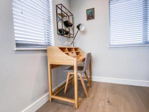 escritorio en una habitación con silla y lámpara en Geneva House Apartments by Elegance Living, en Peterborough