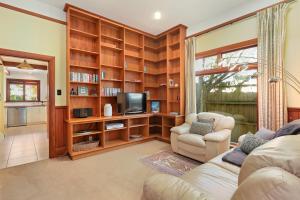 a living room with a couch and a tv at Fendalton Villa - Christchurch Holiday Home in Christchurch