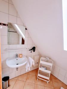 a bathroom with a sink and a mirror at Ambiente Ferienwohnungen in Sankt Martin