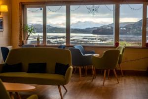 a waiting room with chairs and a large window at Portree Youth Hostel in Portree